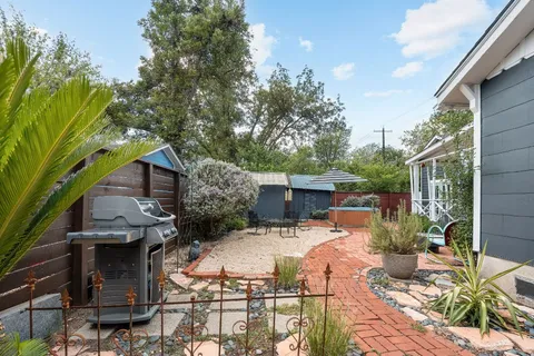 a view of backyard of house with seating space