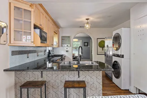 a kitchen with stainless steel appliances granite countertop a stove and cabinets