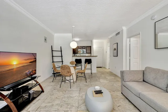 a living room with furniture flat screen tv and a window