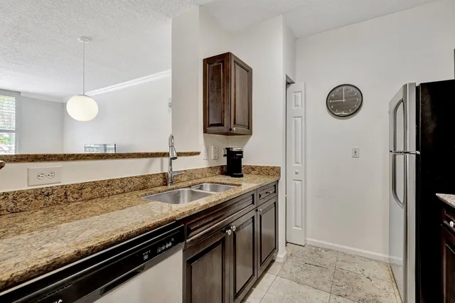 a view of a kitchen counter space and stainless steel appliances