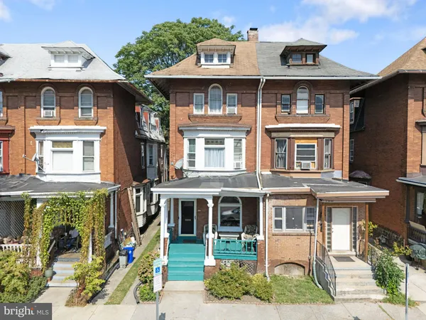 a front view of a residential apartment building with a yard