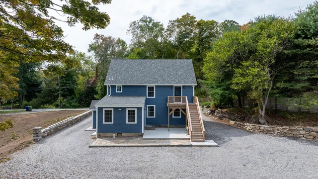 an aerial view of a house with a yard