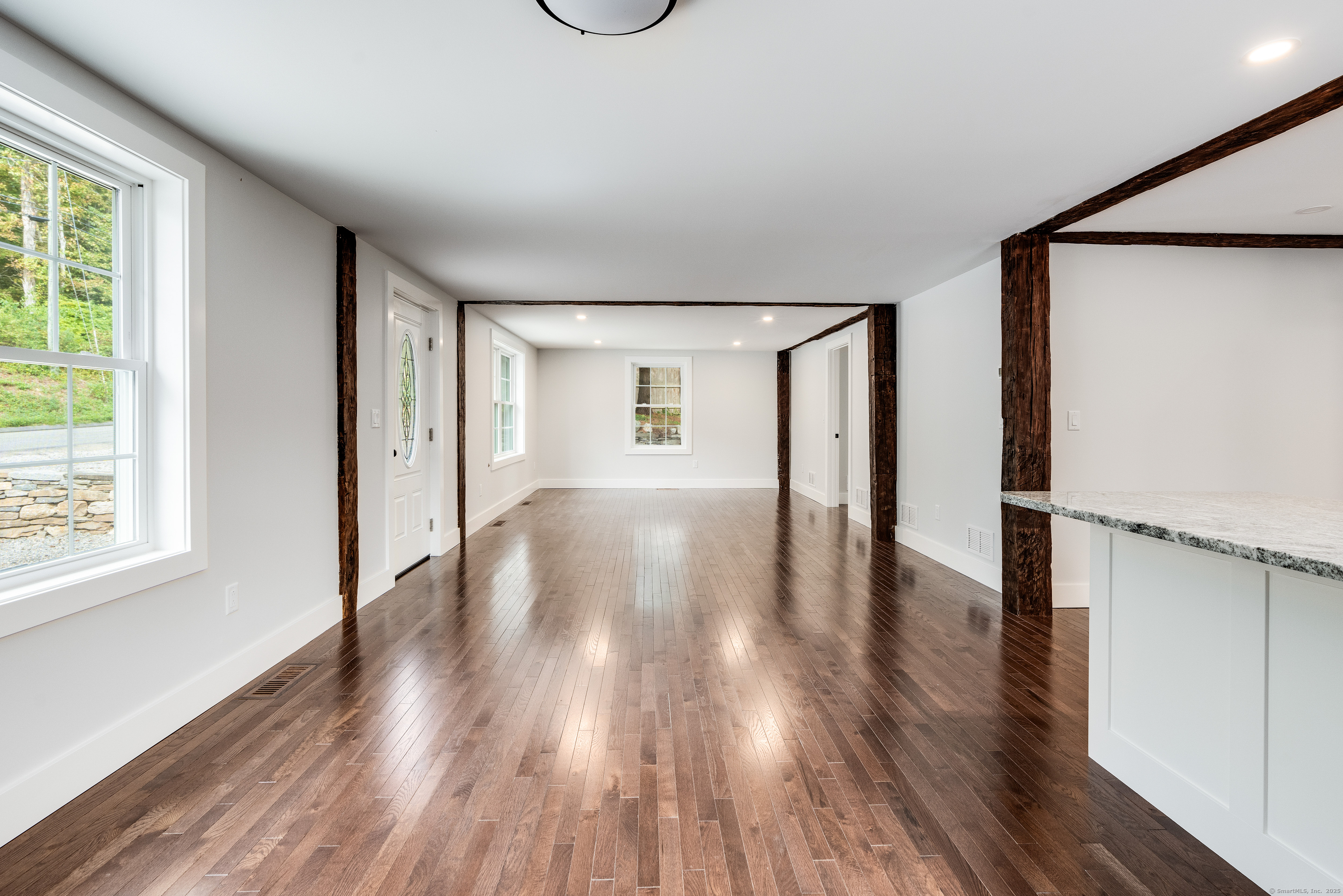 60 Goose Hill Road Chester, CT 06412 - Photo 10 of 35 a view of an empty room with wooden floor and a window