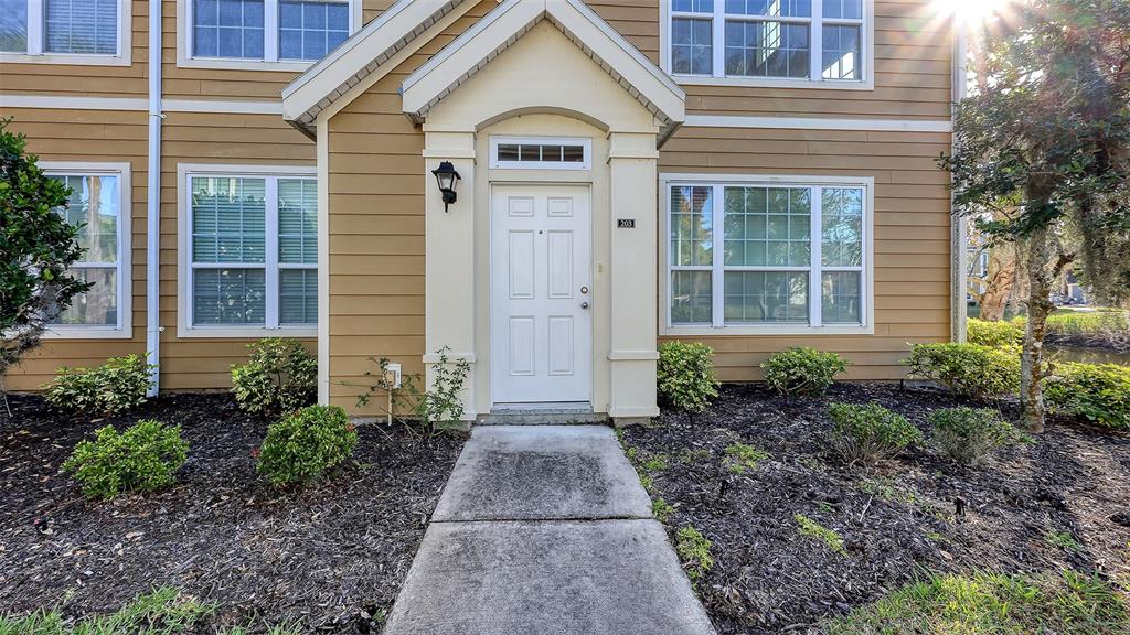 5520 Rosehill Road, Unit 203 Sarasota, FL 34233 - Photo 1 of 46 a view of a brick house with yard and plants