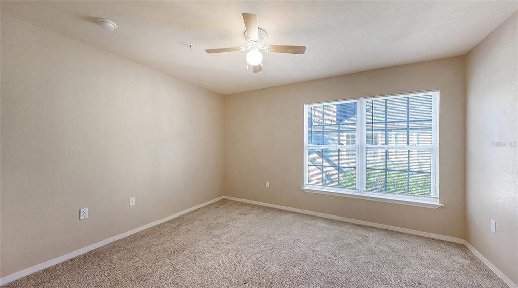 5520 Rosehill Road, Unit 203 Sarasota, FL 34233 - Photo 17 of 46 an empty room with a window and a ceiling fan