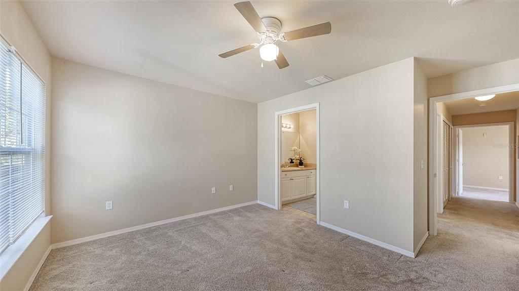 5520 Rosehill Road, Unit 203 Sarasota, FL 34233 - Photo 18 of 46 an empty room with closet and a ceiling fan