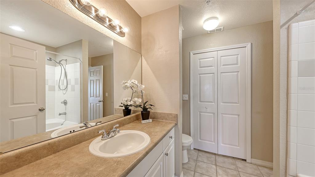 5520 Rosehill Road, Unit 203 Sarasota, FL 34233 - Photo 19 of 46 a bathroom with a granite countertop sink a mirror and a shower