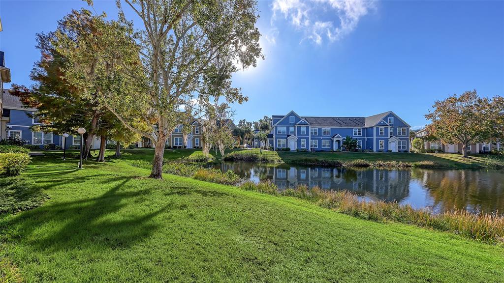 5520 Rosehill Road, Unit 203 Sarasota, FL 34233 - Photo 30 of 46 a view of a house with a yard and a pond
