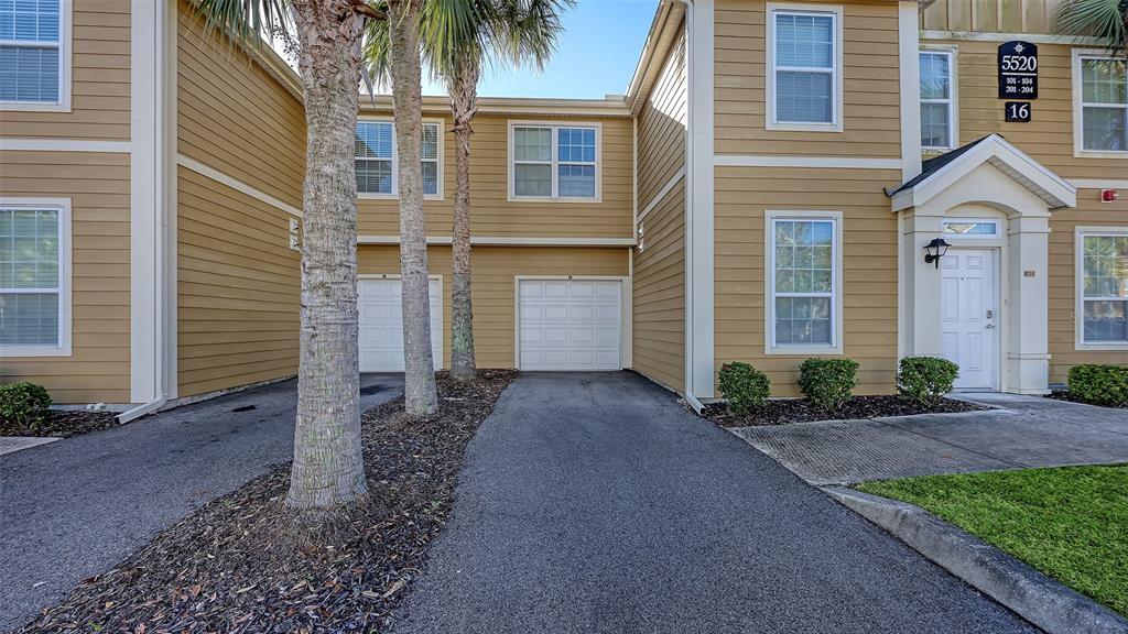 5520 Rosehill Road, Unit 203 Sarasota, FL 34233 - Photo 32 of 46 a view of a brick house with many windows and palm trees