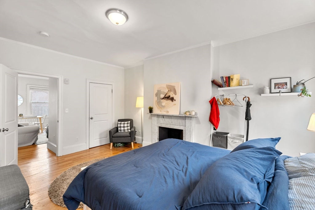 62 West Cedar Street, Unit 3 Boston, MA 02114 - Photo 11 of 18 a bedroom with a bed and a chandelier