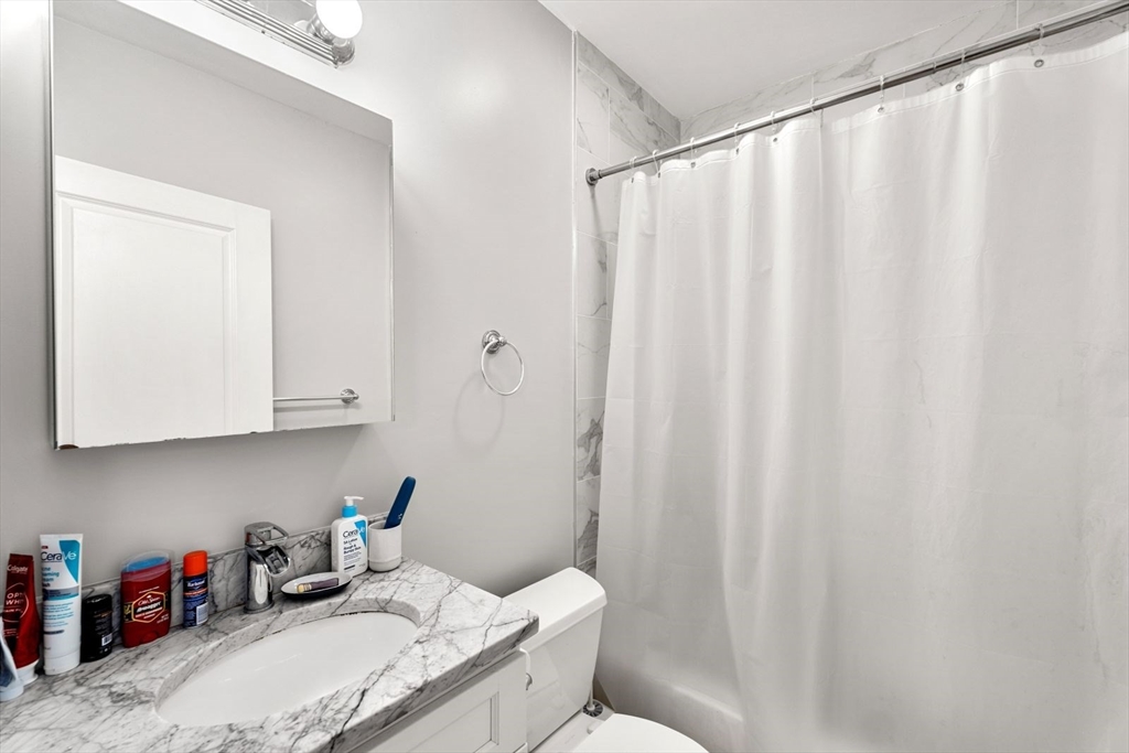 62 West Cedar Street, Unit 3 Boston, MA 02114 - Photo 15 of 18 a bathroom with a sink curtain and curtain