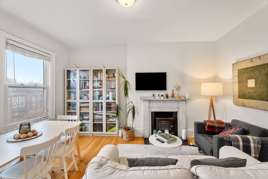 62 West Cedar Street, Unit 3 Boston, MA 02114 - Photo 2 of 18 a living room with furniture fireplace and a flat screen tv