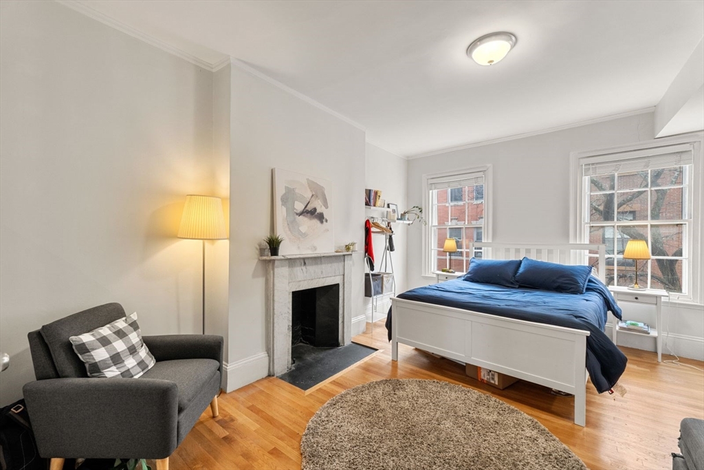 62 West Cedar Street, Unit 3 Boston, MA 02114 - Photo 9 of 18 a bed room with furniture and a fireplace