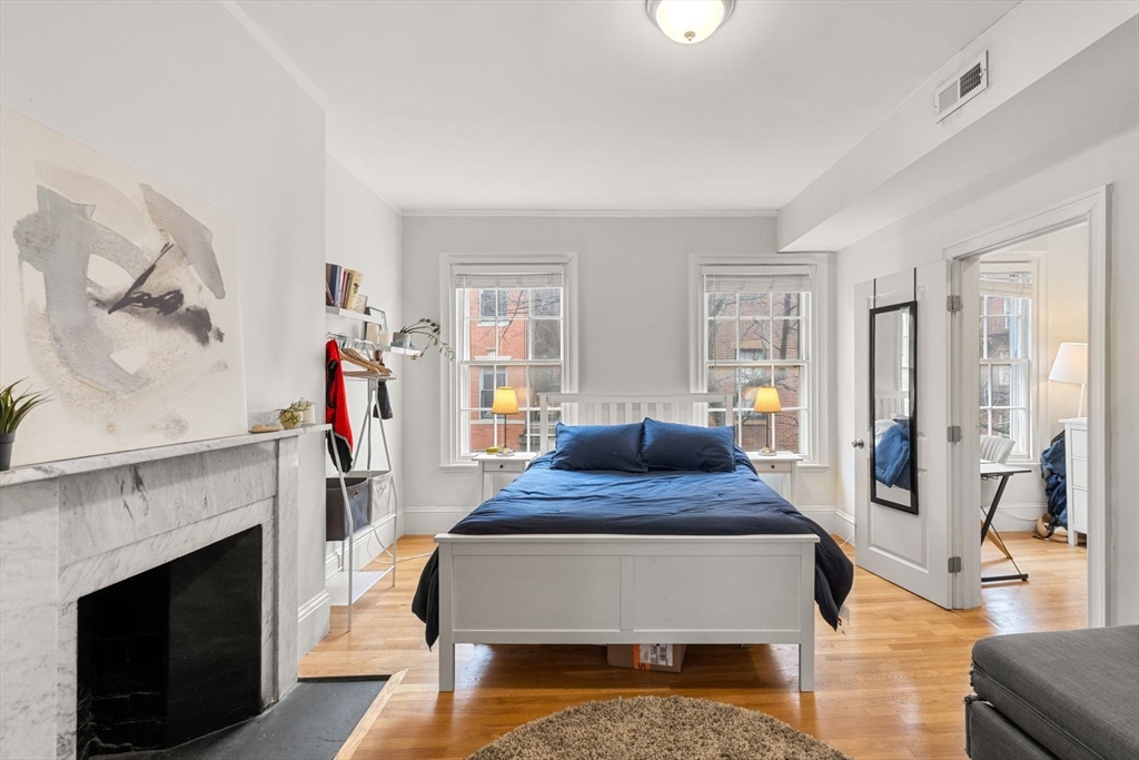 62 West Cedar Street, Unit 3 Boston, MA 02114 - Photo 10 of 18 a bedroom with a bed and a fireplace