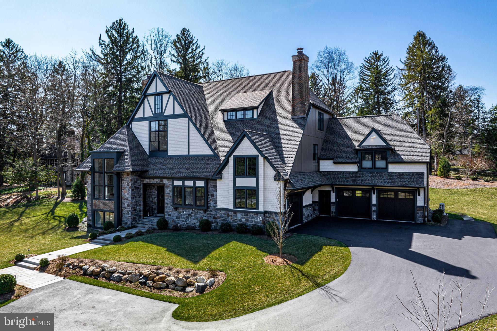 10 Tunbridge Road Haverford, PA 19041 - Photo 2 of 3 a front view of a house with a garden and trees