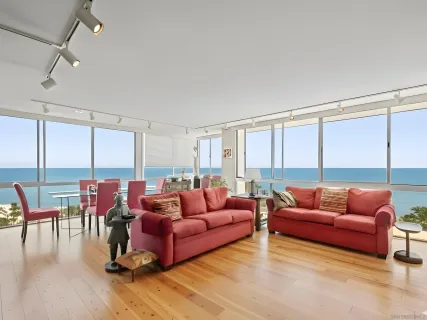 a living room with furniture city view and large windows