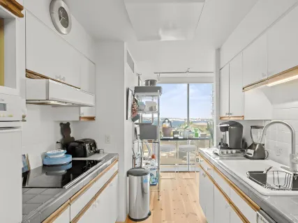 a kitchen with kitchen island granite countertop a sink and a stove top oven