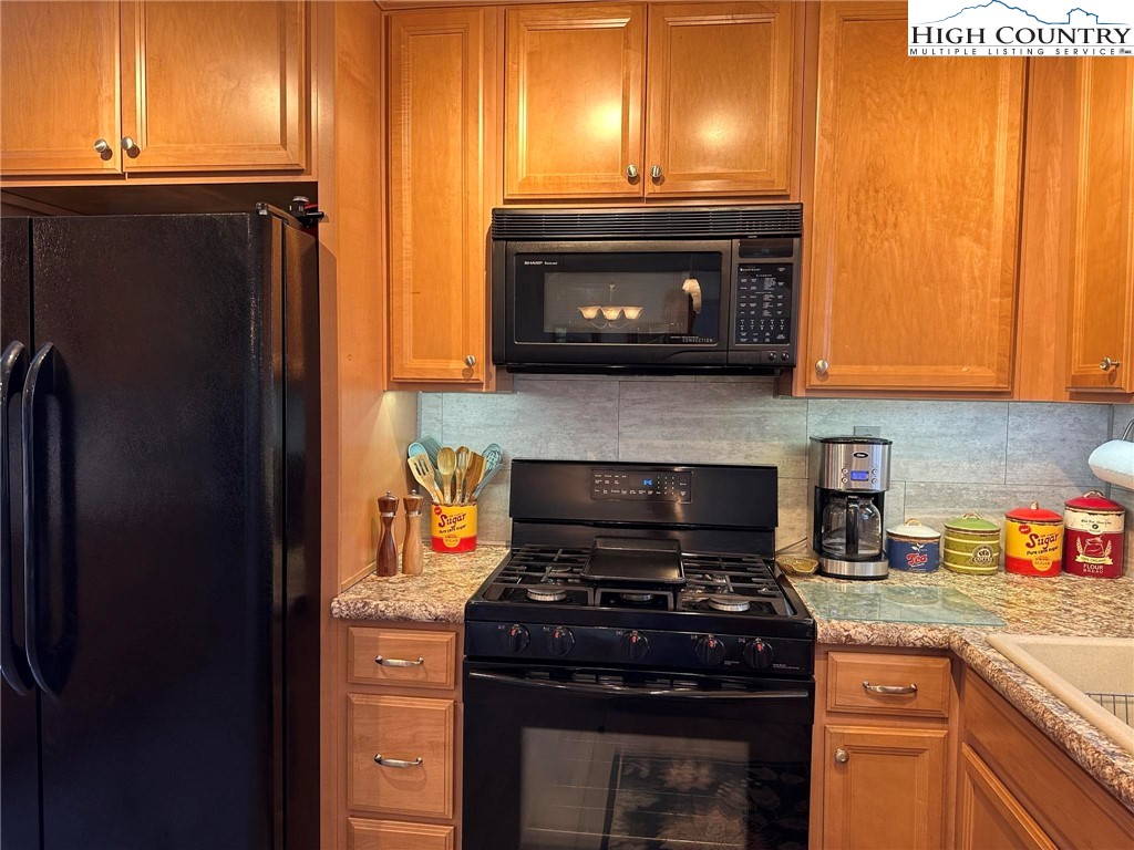 4952 Nile Road Sparta, NC 28675 - Photo 11 of 36 a kitchen with stainless steel appliances granite countertop a stove and a refrigerator