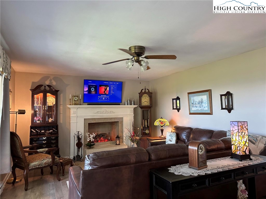 4952 Nile Road Sparta, NC 28675 - Photo 12 of 36 a living room with furniture a fireplace and a flat screen tv