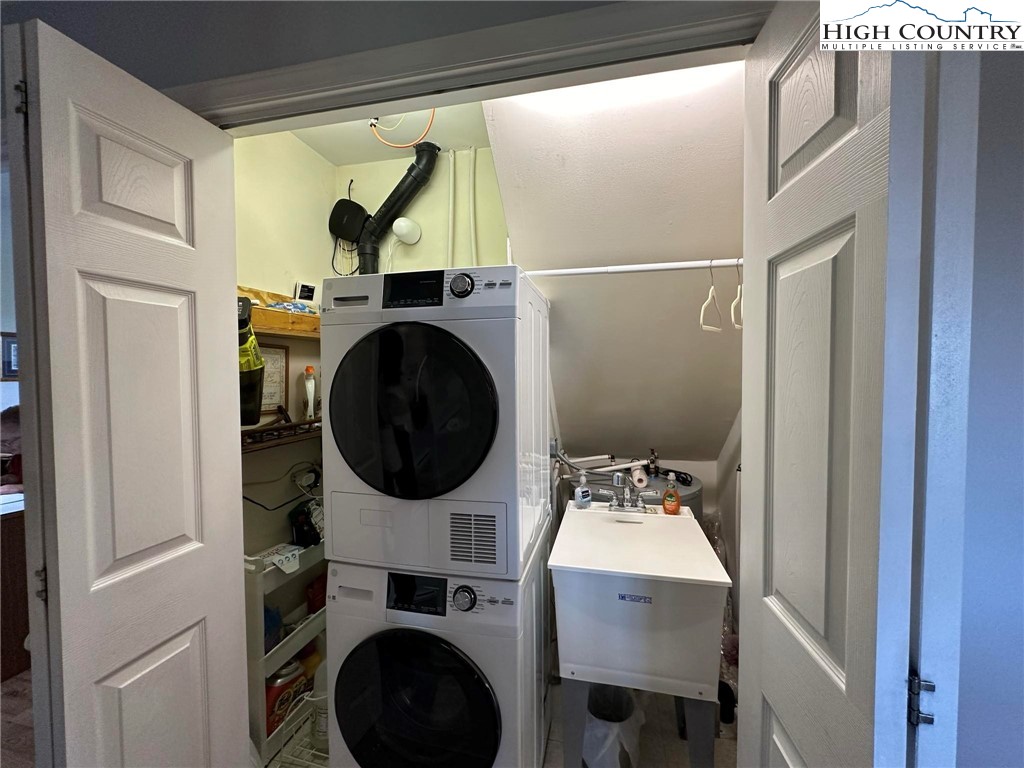 4952 Nile Road Sparta, NC 28675 - Photo 15 of 36 a utility room with dryer washer and a view of living room