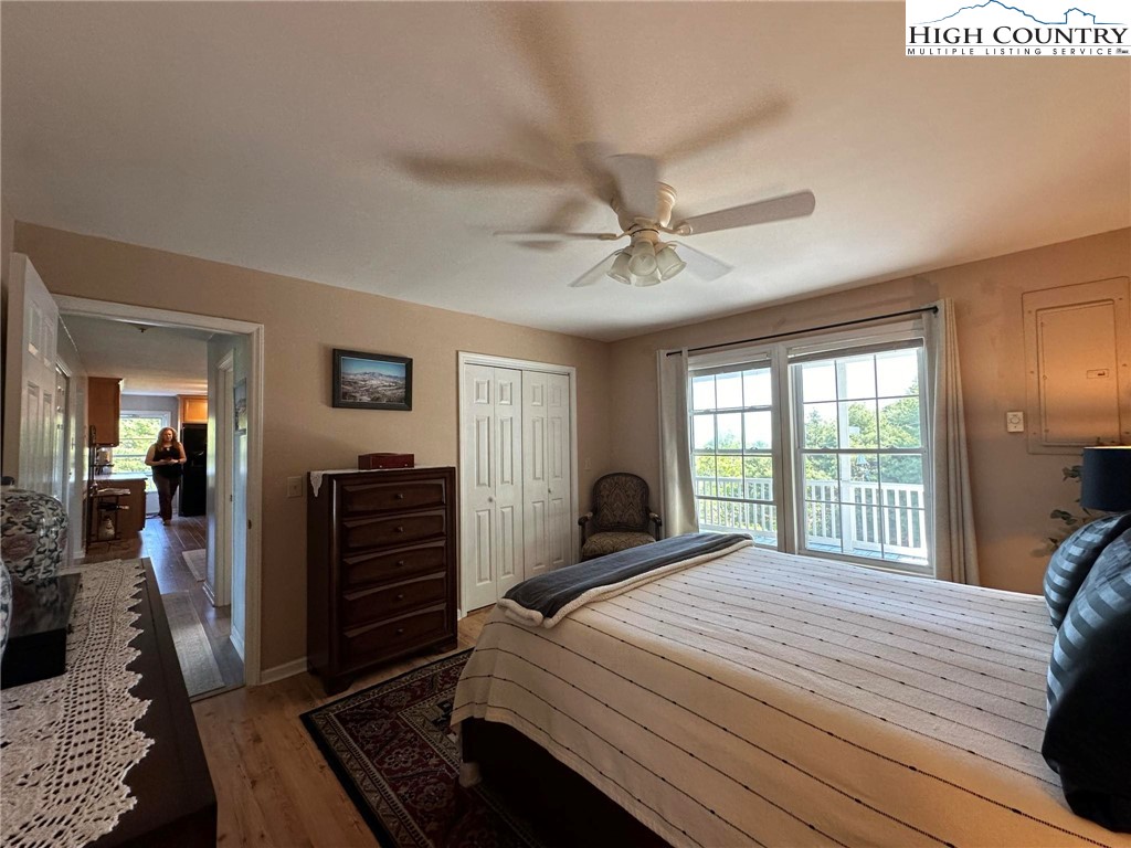 4952 Nile Road Sparta, NC 28675 - Photo 19 of 36 a bedroom with a large bed and a chandelier