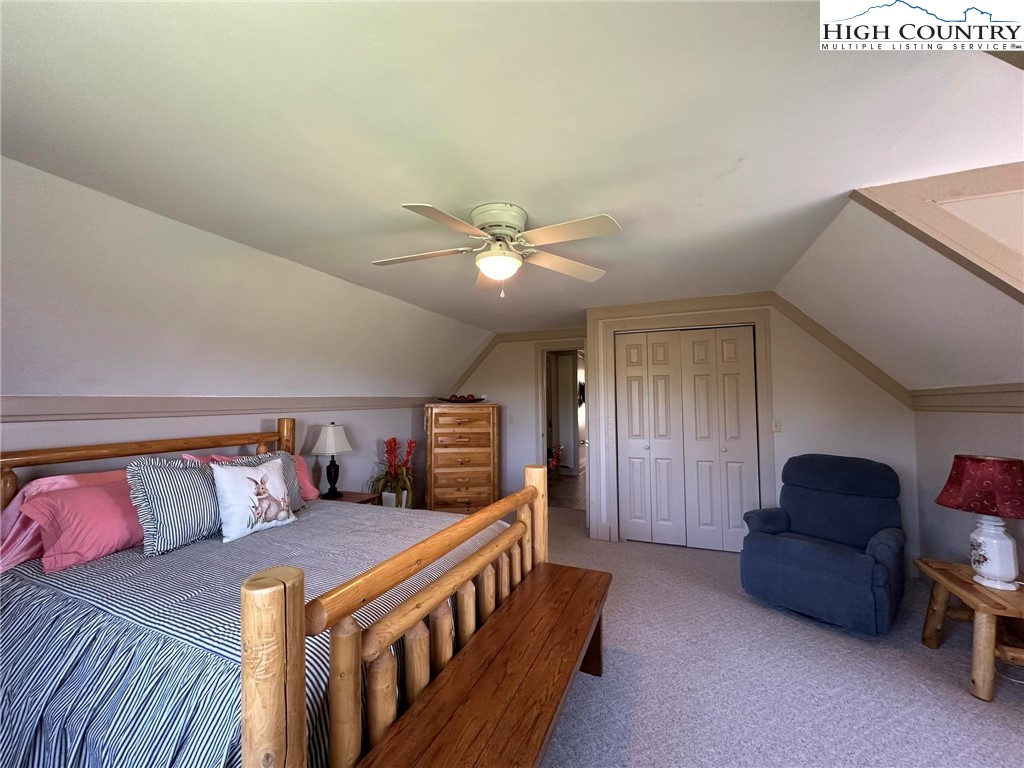 4952 Nile Road Sparta, NC 28675 - Photo 27 of 36 a bedroom with a bed and a chandelier