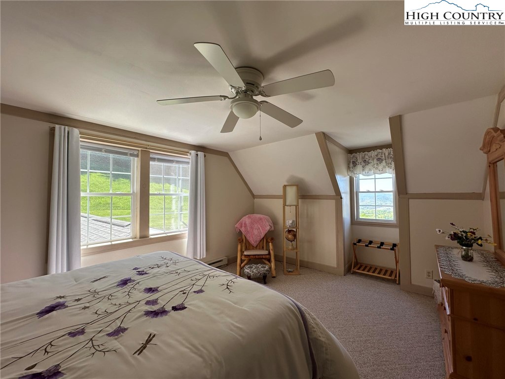 4952 Nile Road Sparta, NC 28675 - Photo 29 of 36 a bedroom with a bed and large windows
