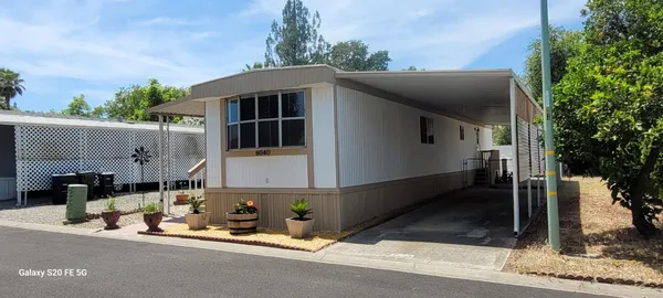 a front view of a house with sitting area
