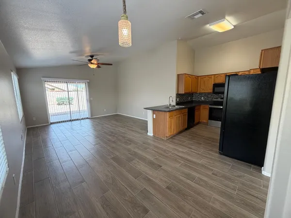 a kitchen with a refrigerator and a stove top oven
