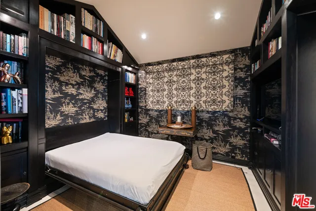 a bed room with a bed and a book shelf