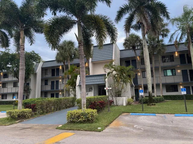 a front view of multiple houses with yard
