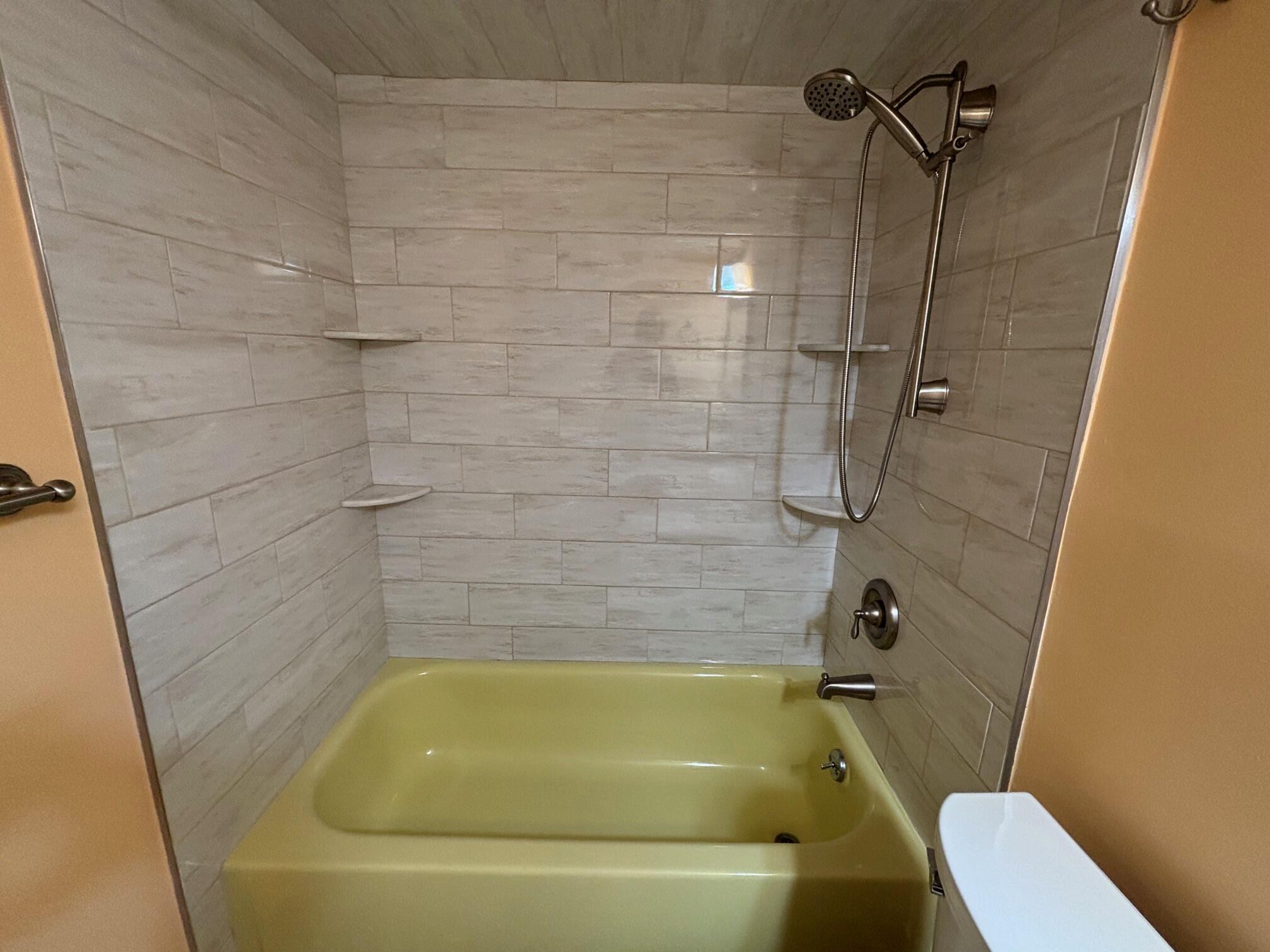 4411 Trevi Court, Unit 106 Lake Worth, FL 33467 - Photo 15 of 21 a bathroom with a tub and toilet