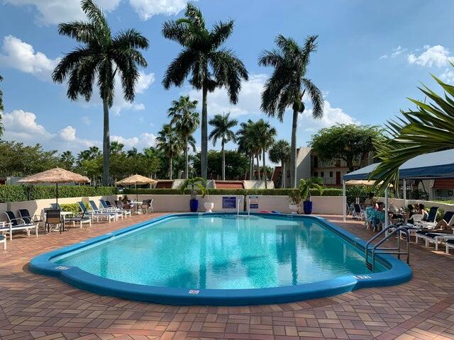 4411 Trevi Court, Unit 106 Lake Worth, FL 33467 - Photo 17 of 21 a view of a swimming pool with chairs