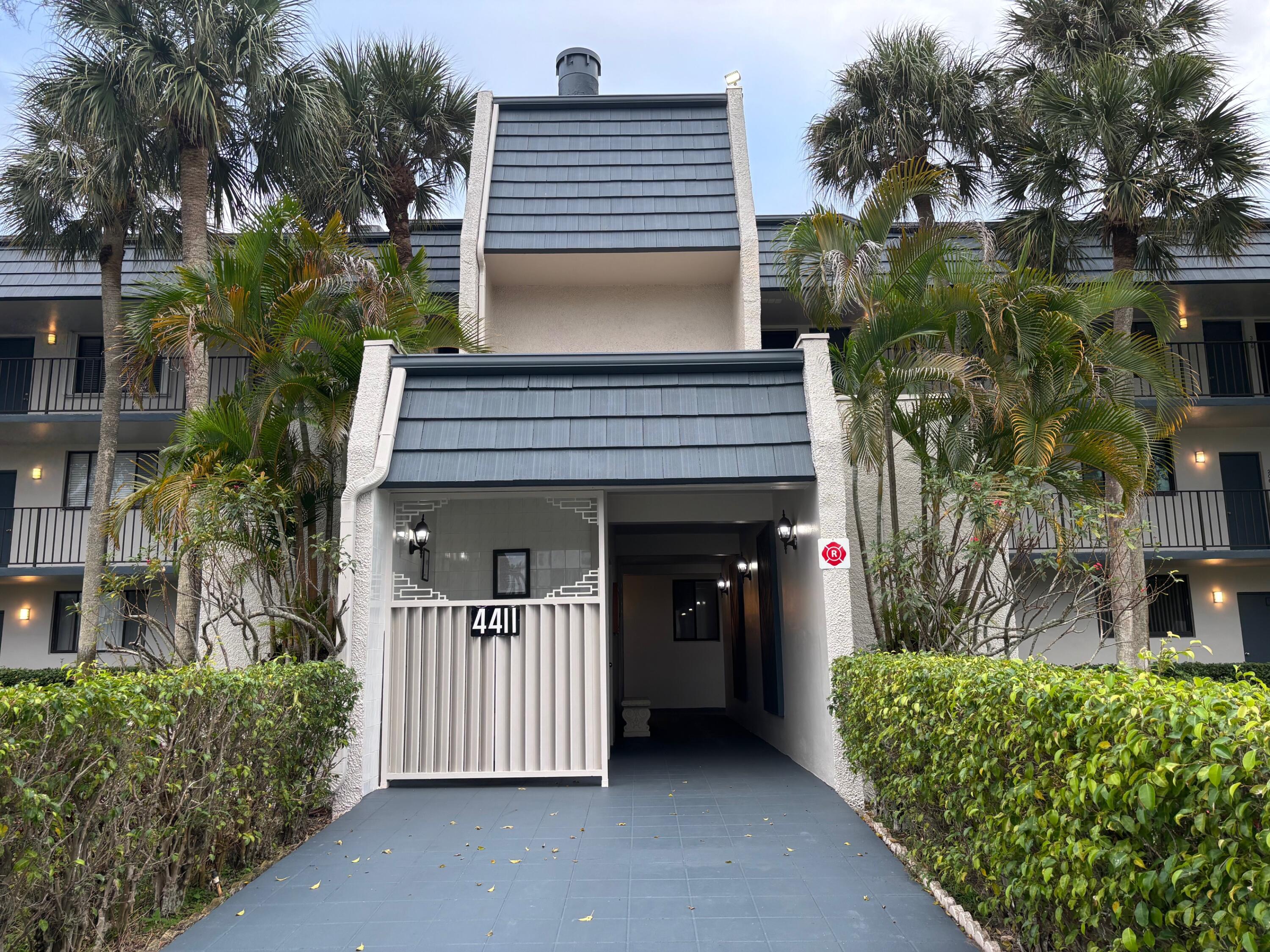 4411 Trevi Court, Unit 106 Lake Worth, FL 33467 - Photo 19 of 21 front view of a house with a yard