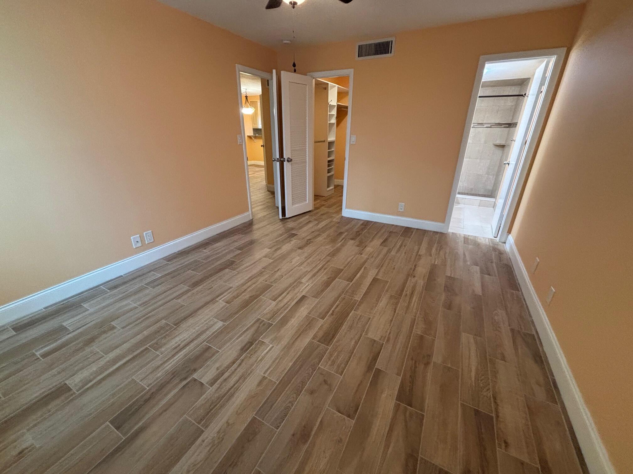 4411 Trevi Court, Unit 106 Lake Worth, FL 33467 - Photo 8 of 21 a view of wooden floor and brick walls