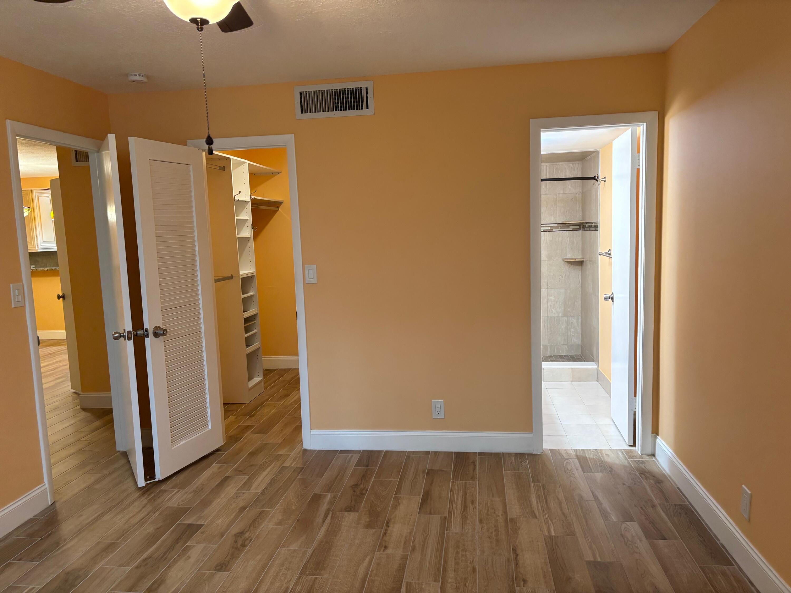 4411 Trevi Court, Unit 106 Lake Worth, FL 33467 - Photo 9 of 21 a view of a bathroom with wooden floor