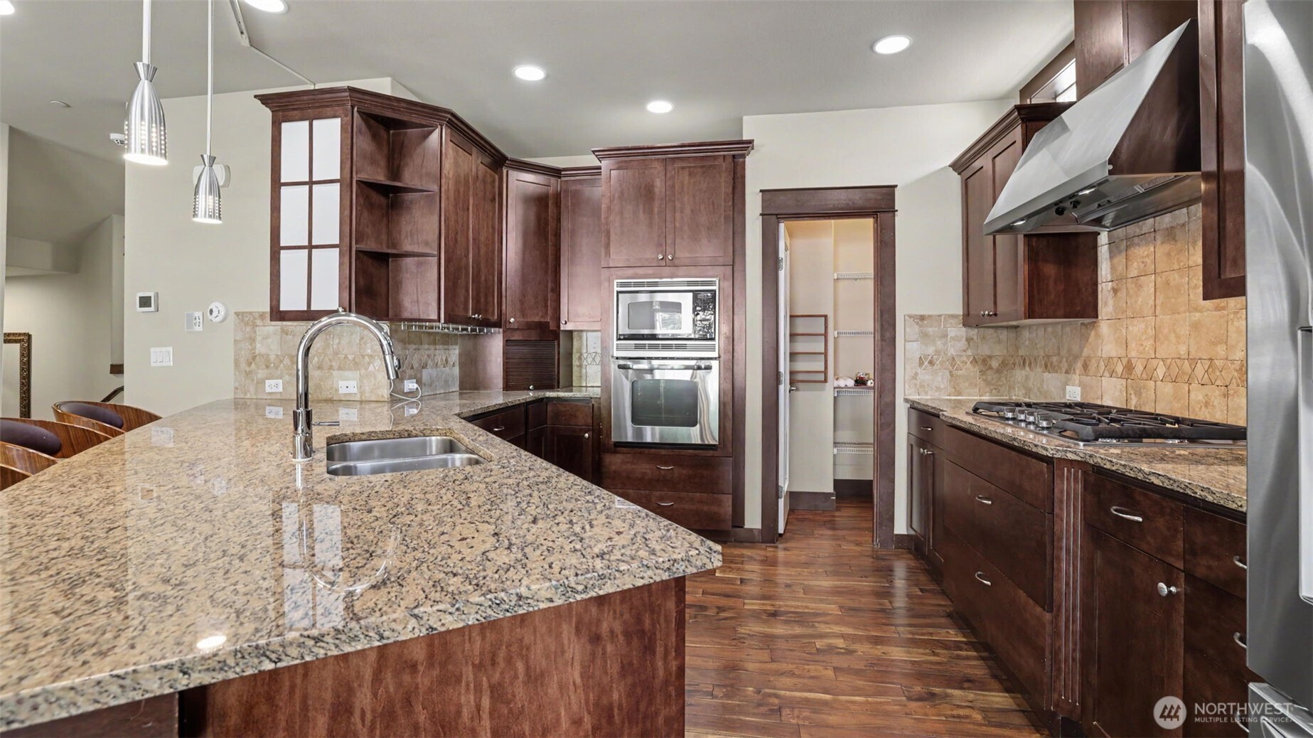 1357 Elma Place Northeast Renton, WA 98059 - Photo 10 of 40 a kitchen with stainless steel appliances granite countertop a sink stove and refrigerator