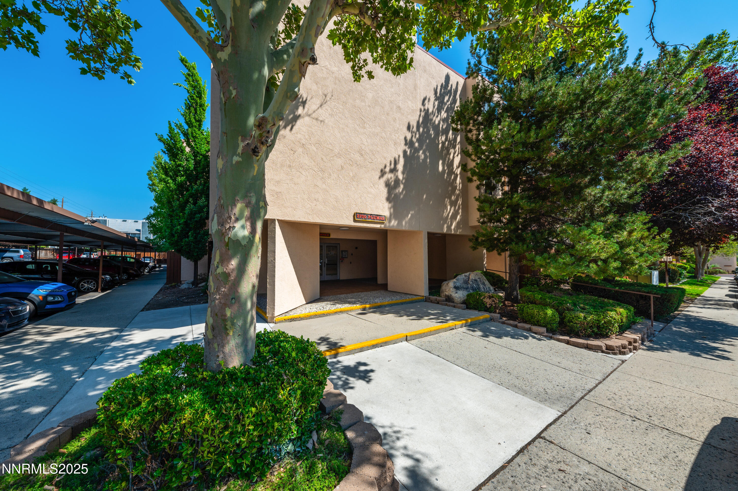 2700 Plumas Street, Unit 211 Reno, NV 89509 - Photo 11 of 11 a front view of a house with a yard and trees