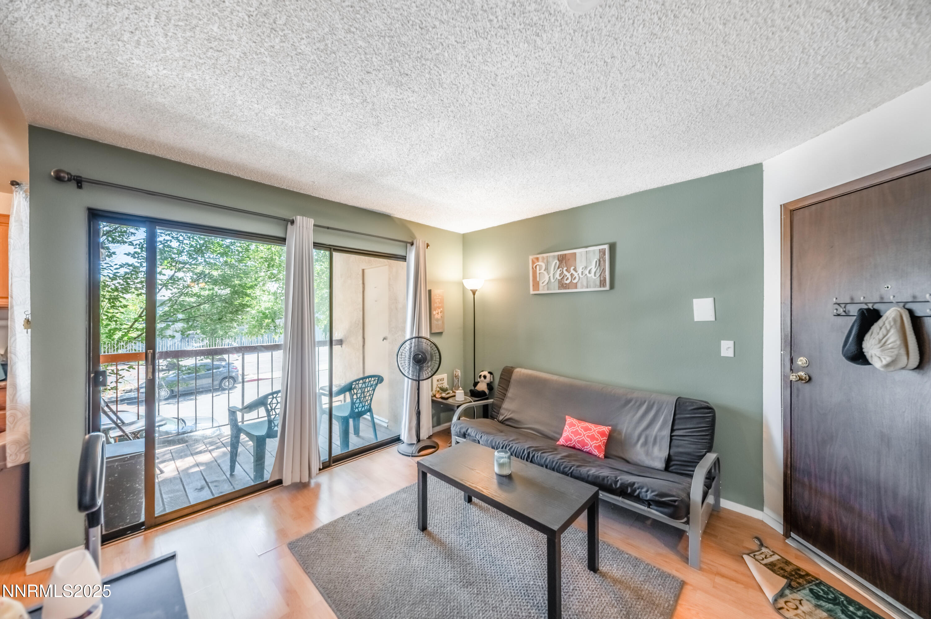 2700 Plumas Street, Unit 211 Reno, NV 89509 - Photo 2 of 11 a living room with furniture and a gate