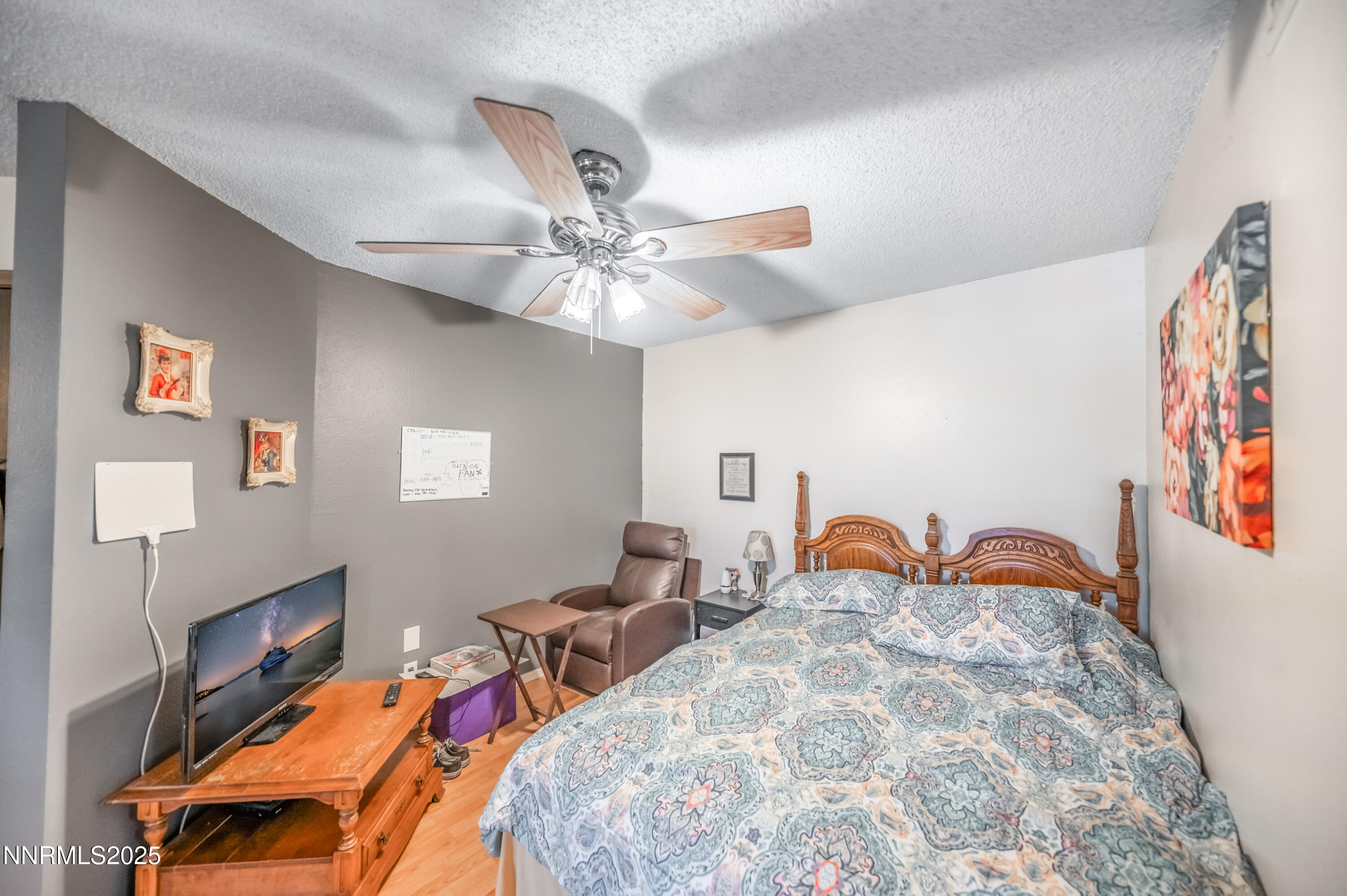 2700 Plumas Street, Unit 211 Reno, NV 89509 - Photo 3 of 11 a bedroom with furniture and a chandelier