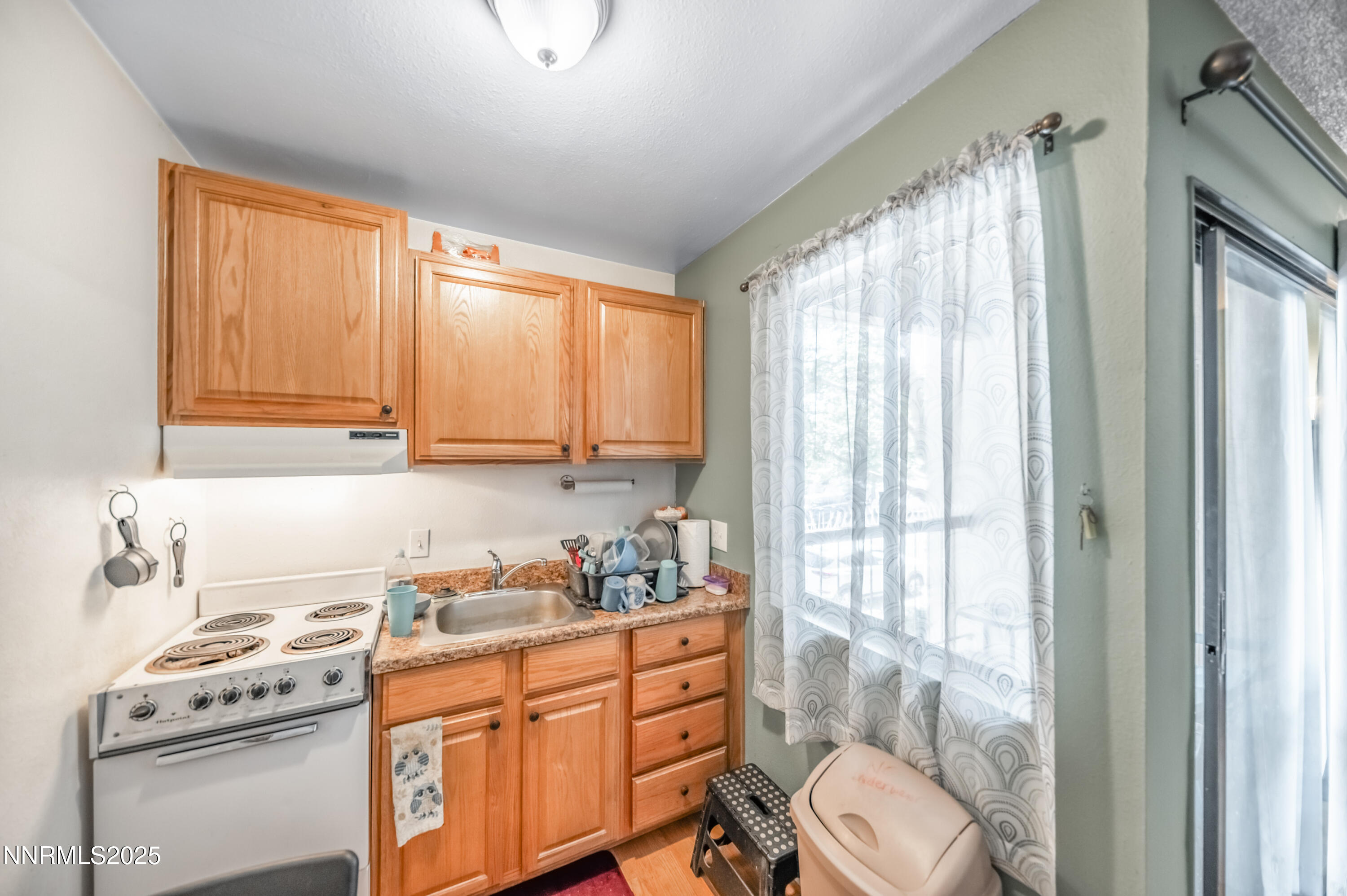 2700 Plumas Street, Unit 211 Reno, NV 89509 - Photo 4 of 11 a kitchen with a window a sink and a stove top oven