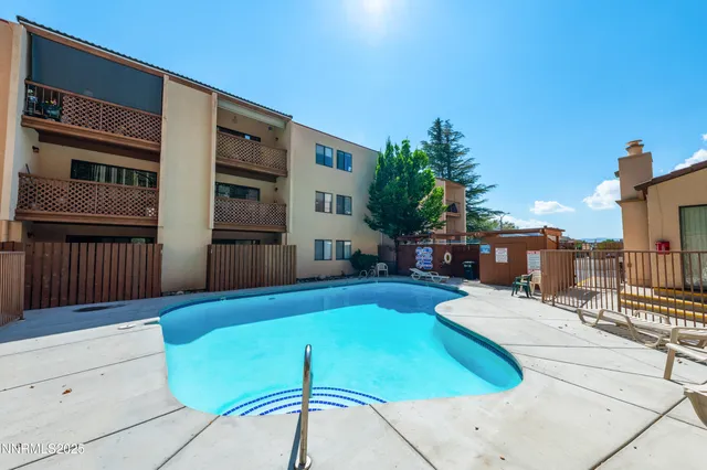 a view of a house with swimming pool in front of it