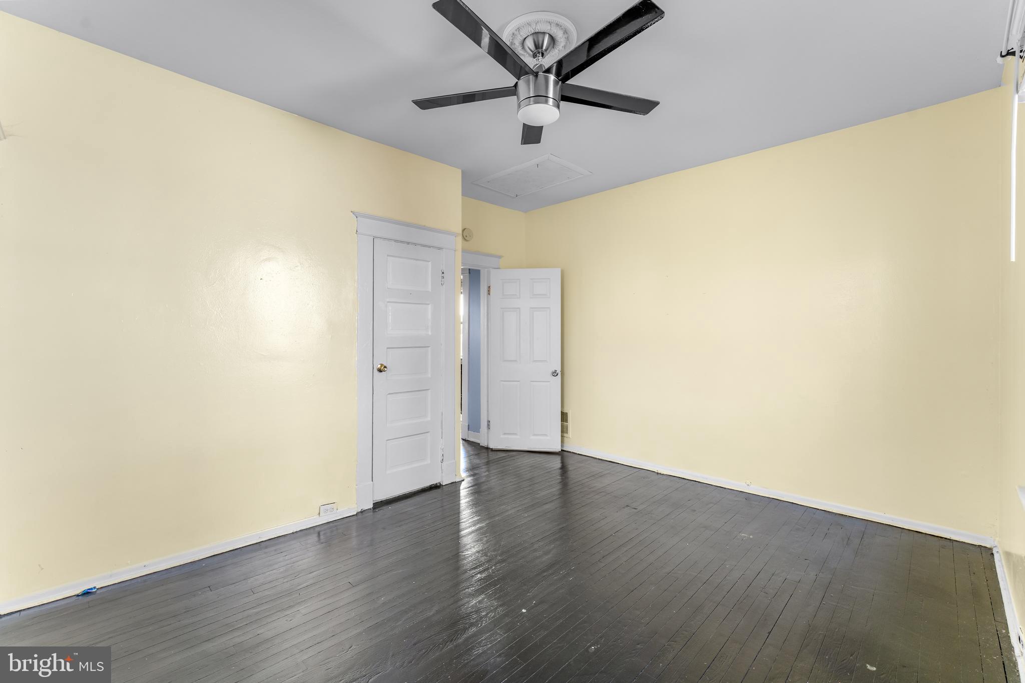 608 Tunbridge Road Baltimore, MD 21212 - Photo 15 of 27 a view of a big room with wooden floor and a ceiling fan