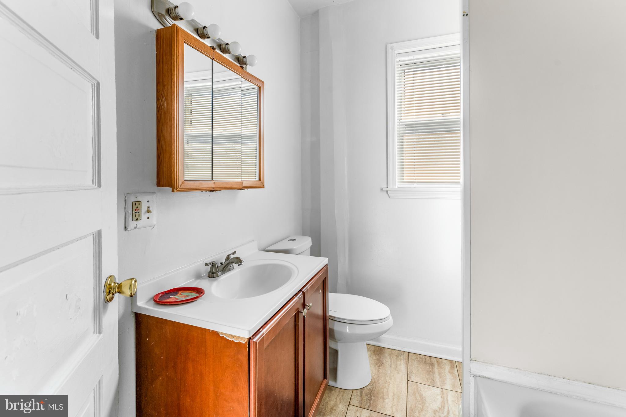608 Tunbridge Road Baltimore, MD 21212 - Photo 16 of 27 a bathroom with a sink vanity and a toilet