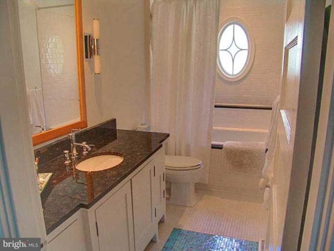 330 Riverside Road Edgewater, MD 21037 - Photo 2 of 26 a bathroom with a granite countertop sink and a mirror