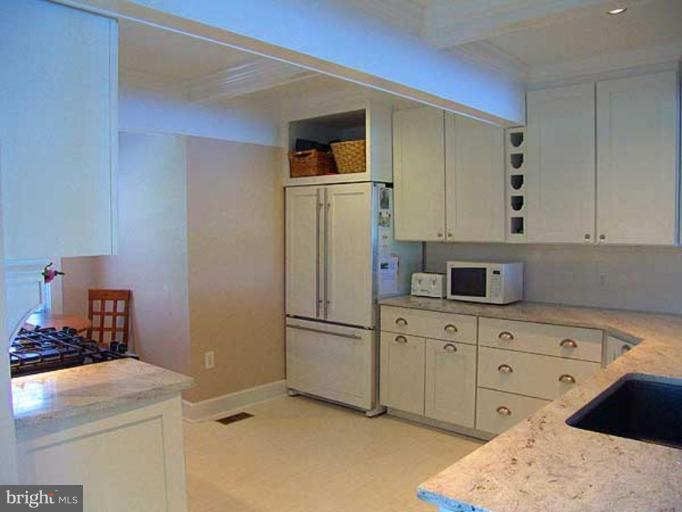 330 Riverside Road Edgewater, MD 21037 - Photo 15 of 26 a kitchen with stainless steel appliances kitchen island a refrigerator sink and cabinets