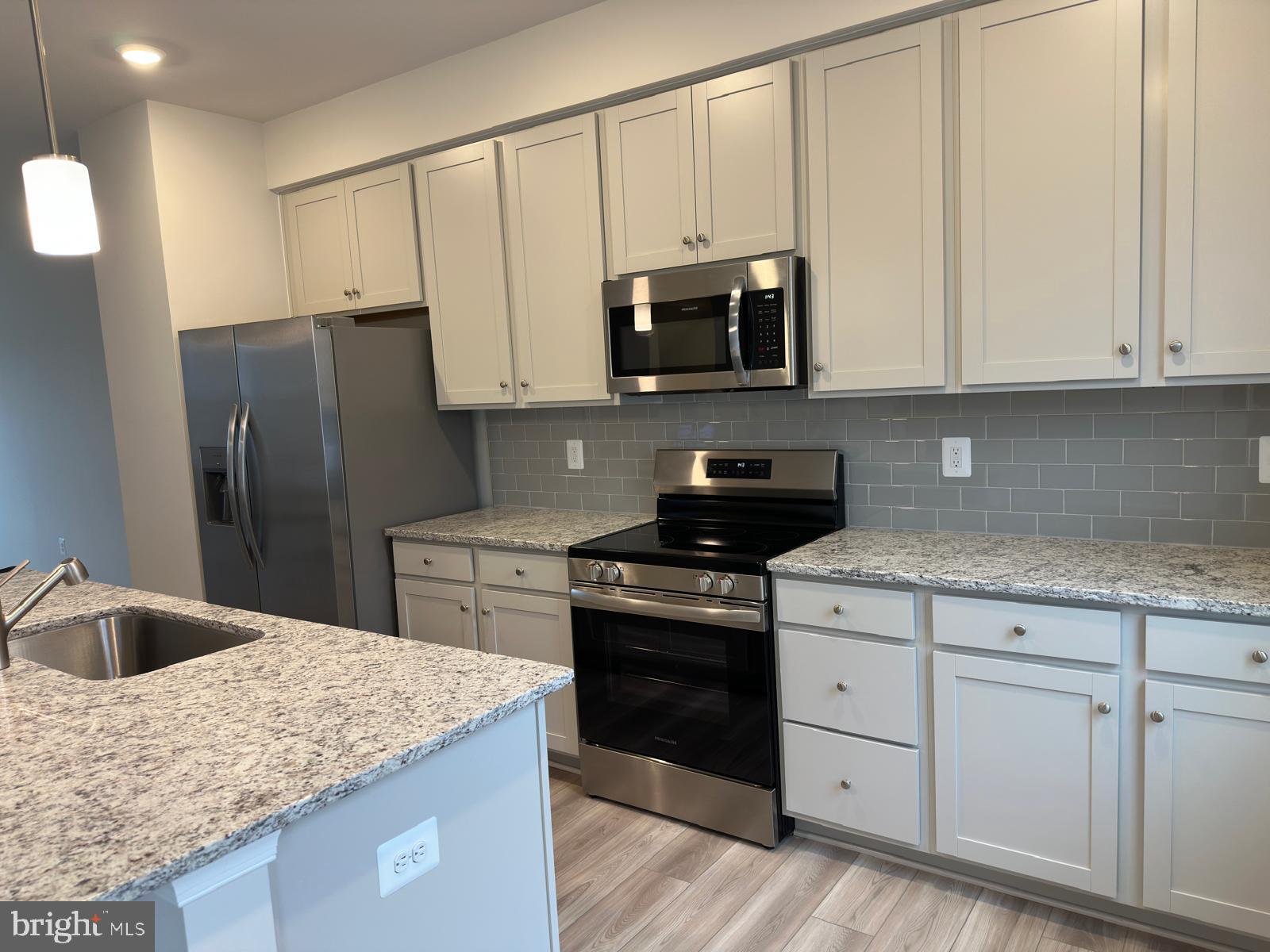 1260 Red Clover Lane Ranson, WV 25438 - Photo 11 of 20 a kitchen with stainless steel appliances granite countertop a sink stove and refrigerator