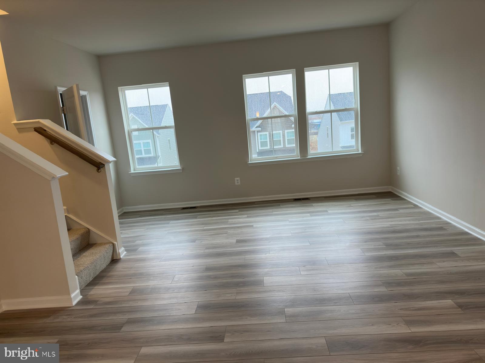 1260 Red Clover Lane Ranson, WV 25438 - Photo 5 of 20 an empty room with wooden floor and windows