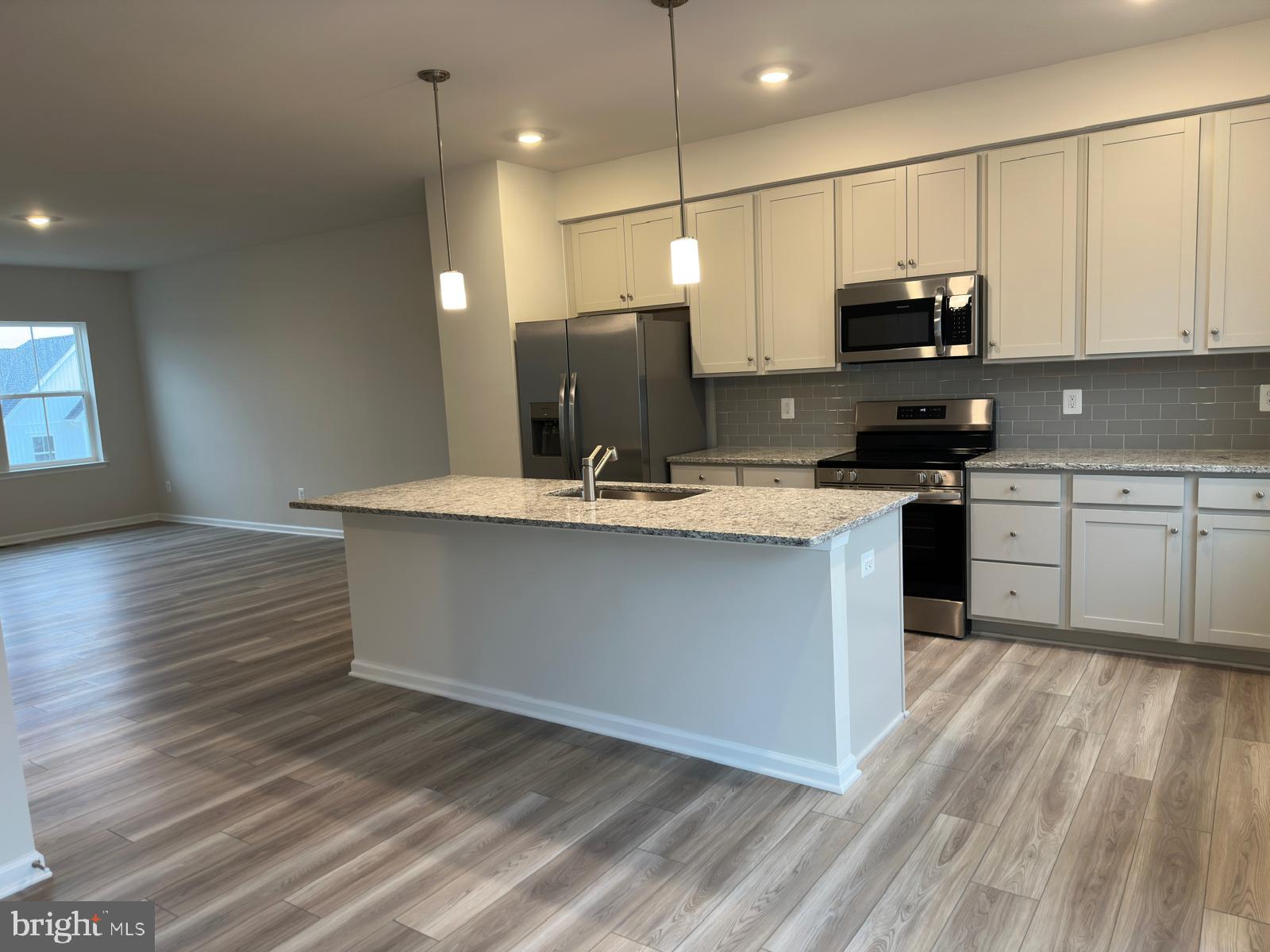 1260 Red Clover Lane Ranson, WV 25438 - Photo 7 of 20 a kitchen with stainless steel appliances granite countertop a sink a stove top oven a counter space and cabinets