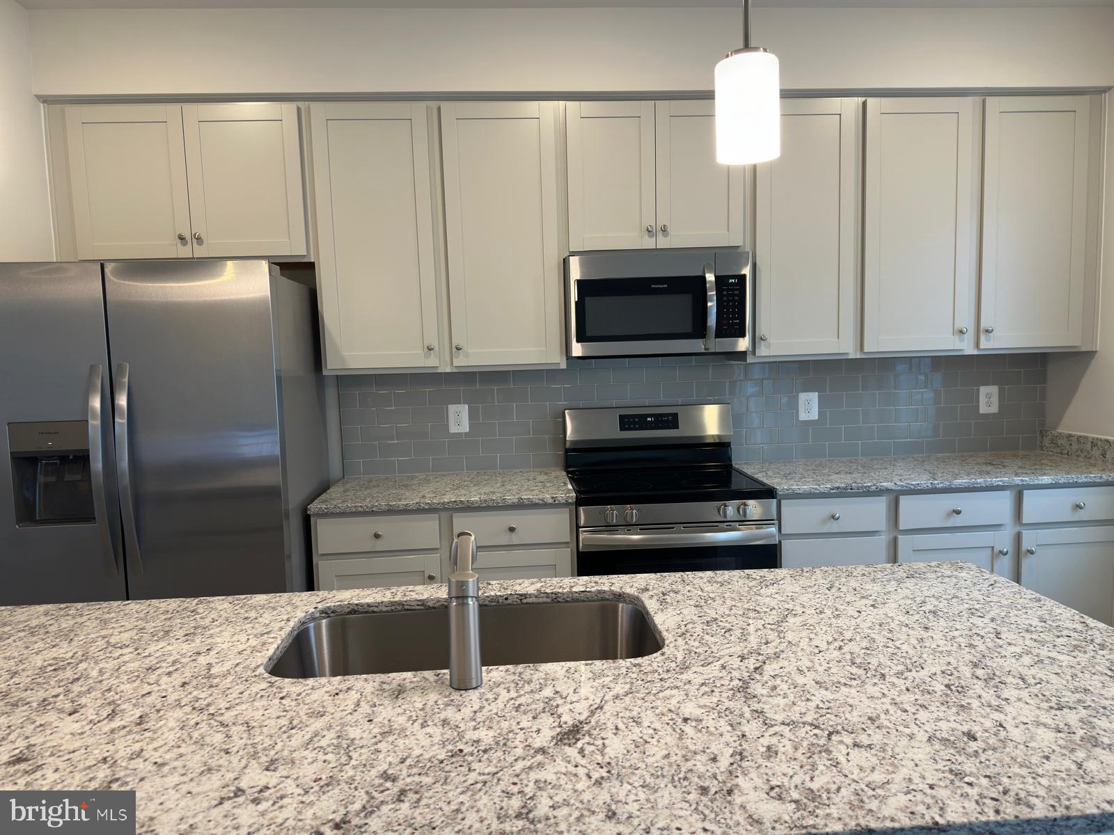1260 Red Clover Lane Ranson, WV 25438 - Photo 8 of 20 a kitchen with stainless steel appliances granite countertop a refrigerator a stove a sink and white cabinets